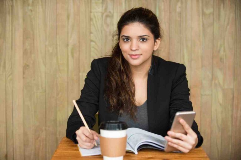 smiling-female-student-doing-homework-desk (1)