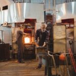 team-glassblowers-shaping-glass-blowpipe_107420-74231