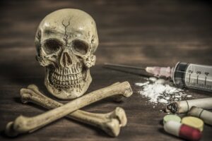 Human skull and crossbones drug addict concept