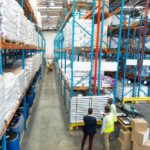 warehouse-staff-discussing-whiteboard-warehouse_13339-358028