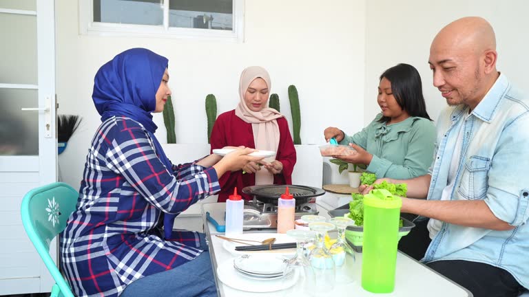 Happy Asian Family Preparing Ingredients To Make Korean BBQ Together