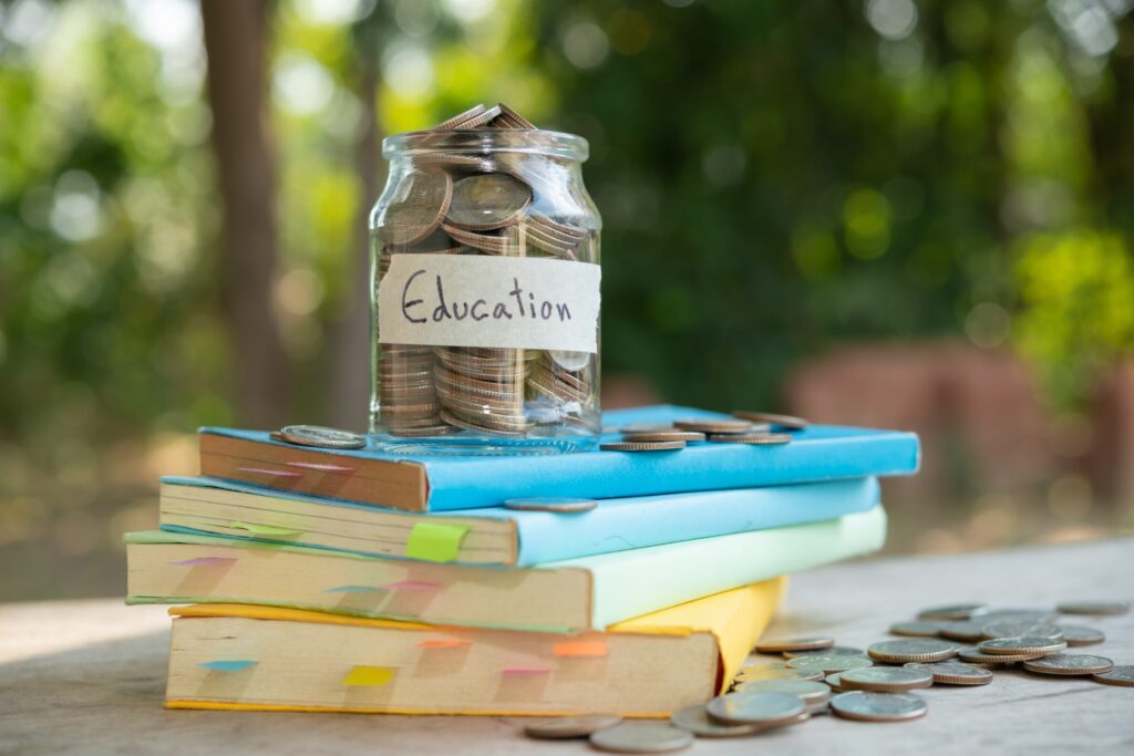 putting-money-coins-saving-glass-bottle-concept-investment-mutual-fund-finance-business-placed-textbook-content-money-saving-education (1) (1)